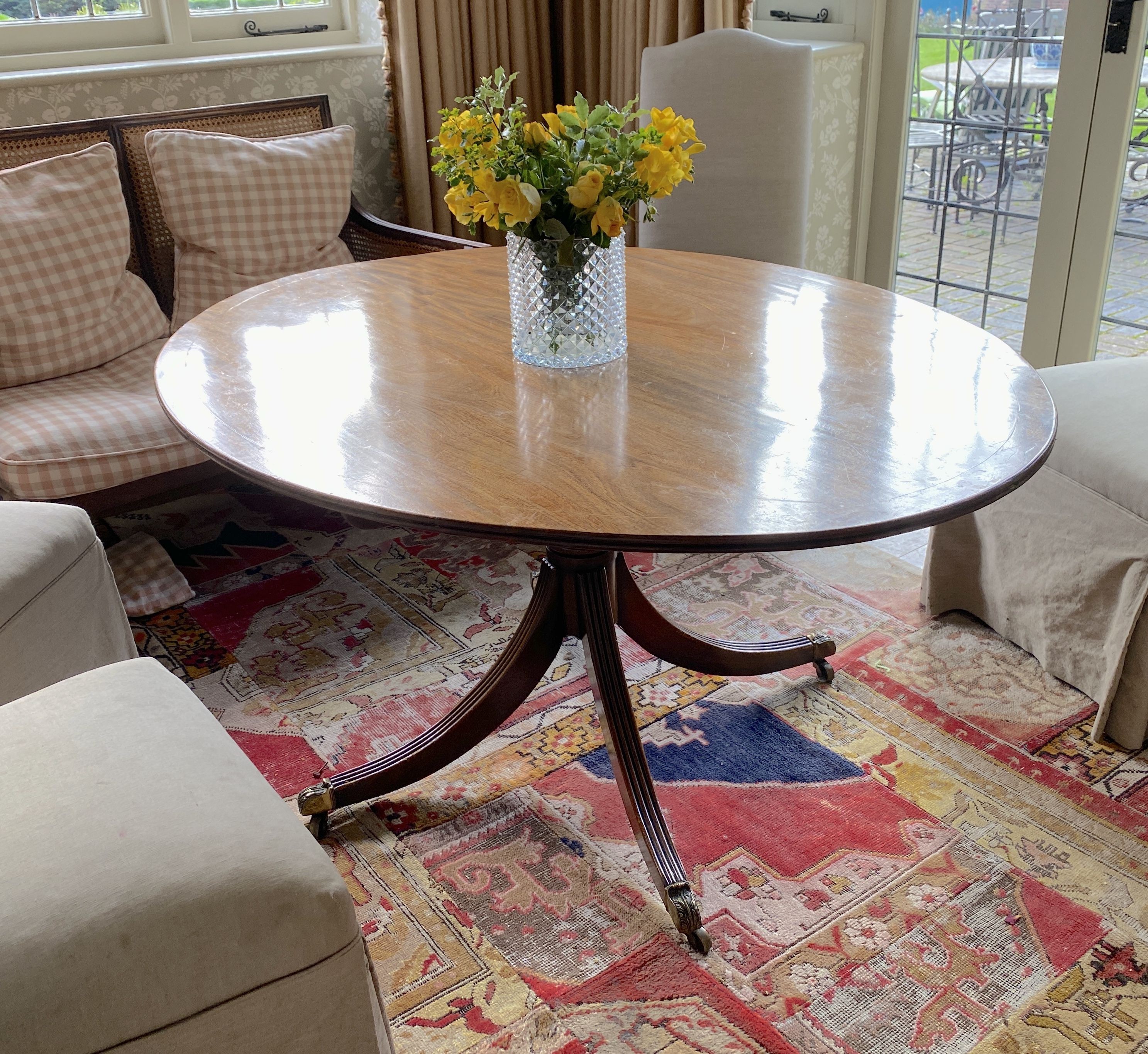 A Regency style mahogany breakfast table, with oval top on reeded downswept legs, width 150cm depth 117cm height 74cm